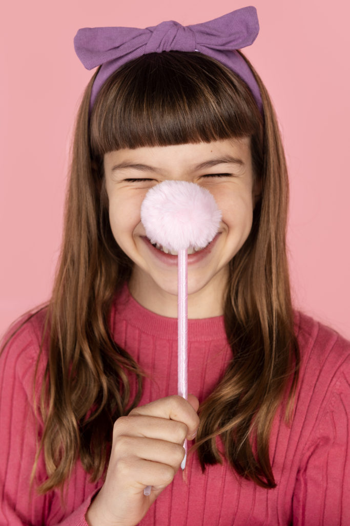 portrait girl posing with pencil laughing